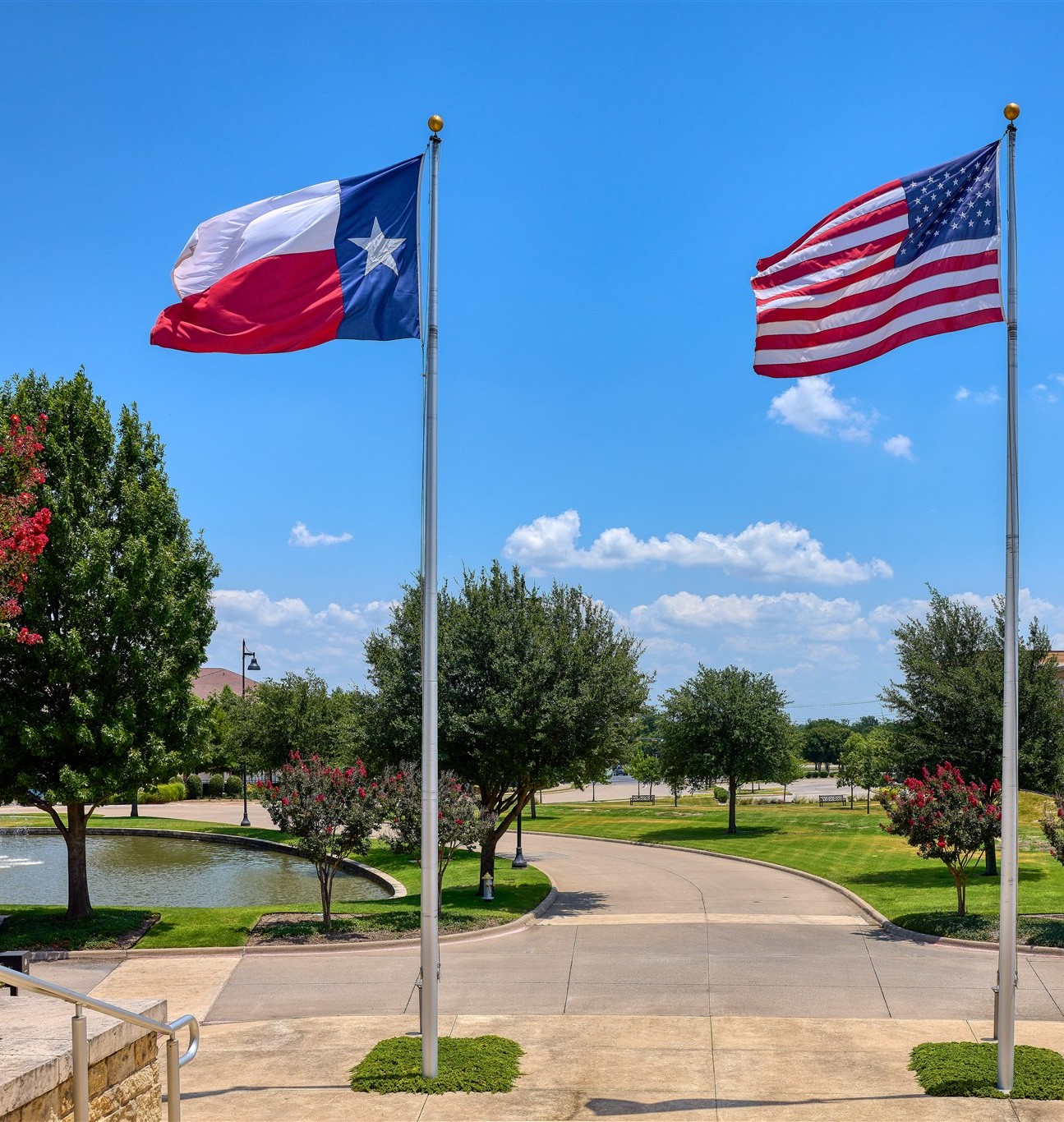 Image of U.S. and Texas flags flying from the viewpoint inside Town Hall