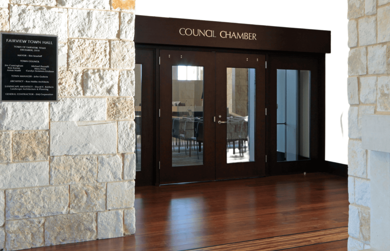 An image of a sign that says "Council Chamber" above double doors leading into a room inside Town Hall
