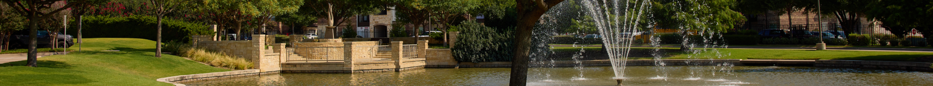 An image of a pond and fountain adjacent to Veterans Park in Fairview